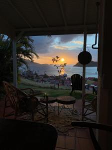 a view of the sunset from the porch of a house at Le Paradis des Rebelles in Terre-de-Haut