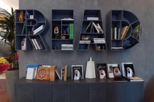 a black desk with bookshelves and books at Pullman Sharjah in Sharjah