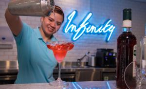 a man pouring a drink into a cocktail at Pullman Sharjah in Sharjah