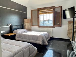 A bed or beds in a room at COMPLEJO RURAL TORRES Y NAVAS