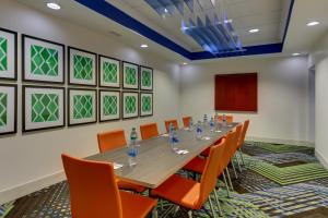 a conference room with a long table and orange chairs at Holiday Inn Express Hotel & Suites Dayton-Centerville by IHG in Centerville +31 photos
