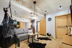 un soggiorno con divano e tavolo di VIP Apartamenty, ORKANA APART a Zakopane