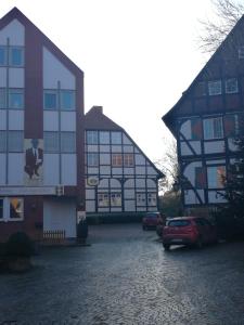 a building with a car parked in front of it at Pension Zum Angestellten in Porta Westfalica