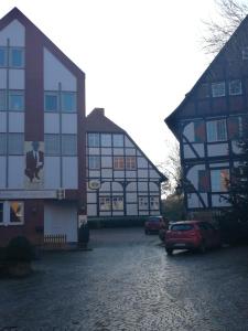 a building with a car parked in front of it at Pension Zum Angestellten in Porta Westfalica