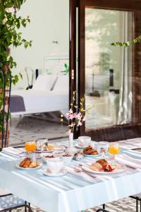 una mesa blanca con platos de comida. en Agalia Luxury Suites, en Tzamaria