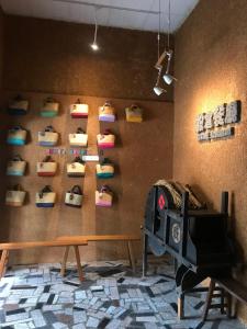 a wall with a bunch of shoes hanging on a wall at Sigang Vacation Homestay in Xigang