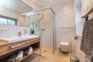 a bathroom with a sink and a shower at Frühstückspension Klinglhub in Flachau