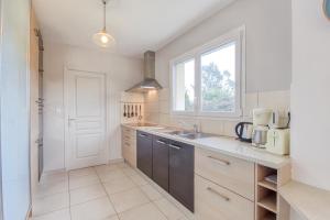 a kitchen with a sink and a window at Iroise in Lamballe +7 photos
