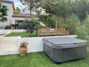 a hot tub on the lawn of a house at HomeStay Bormes in Bormes-les-Mimosas