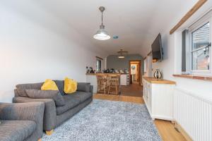 a living room with a couch and a tv at The Shed in Coventry