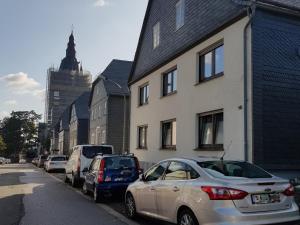 a row of cars parked on the side of a street at Ferienwohnung Alwine Schulte in Brilon