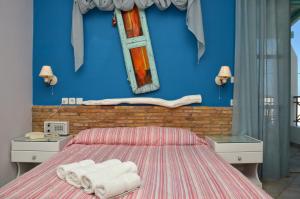 1 dormitorio con 1 cama con toallas en Villa Ostria, en Koufonisia