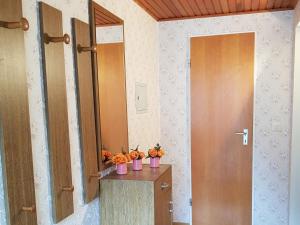 a hallway with two vases of pumpkins on a table at Ferienwohnung Alwine Schulte in Brilon