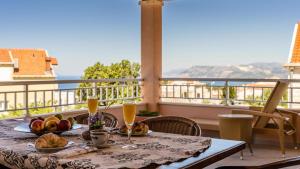 a table with food and drinks on a balcony at Apartment Una in Cavtat