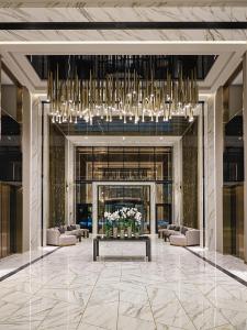 a lobby with couches and a large chandelier at SEA BREEZE LIGHTHOUSE in Baku +68 photos