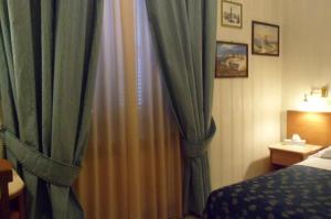 Posteľ alebo postele v izbe v ubytovaní Hotel Alba