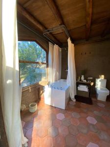 a large bathroom with a tub and a toilet at Big Bang Nature Stays in Sauce de Portezuelo