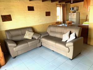 a living room with two couches and a couch at Complejo Vidas del Mar in Punta Del Diablo