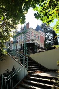 uma escada que leva a uma grande casa branca em Drivers Room em Châtel-Guyon
