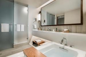 a bathroom with a tub, sink, mirror, and bathtub at Edgewood Tahoe Resort in Stateline