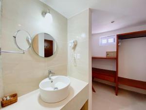 a bathroom with a white sink and a mirror at Rocamar Hotel Isla Mujeres in Isla Mujeres