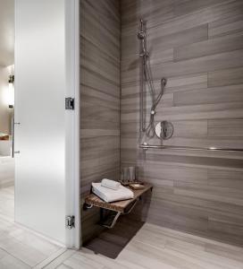 a bathroom with a shower and a bench with towels at Edgewood Tahoe Resort in Stateline