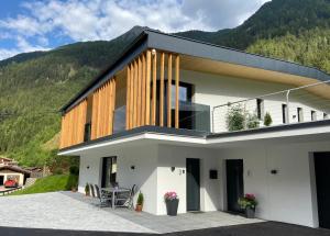 a house with a view of a mountain at Apartment Jasmin in Neustift im Stubaital