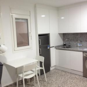 a small kitchen with a white table and chairs at SAN LORENZO STUDIO in Málaga