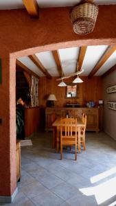 a kitchen and dining room with a table and chairs at Le Pied des Thûres - Family Chalet to host memorable moments! in Névache