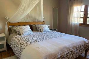 a bedroom with a large bed with pillows at Casita Bioclimatica en el campo in Arucas
