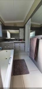 a kitchen with a large tub in a room at Sleepover @194 in Rustenburg