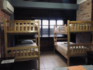 A bed or beds in a room at Tavarua Hotel