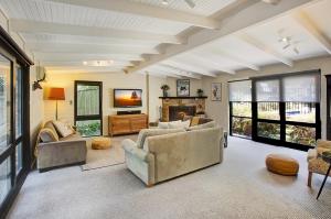 a living room with two couches and a fireplace at Bright River Rest in Bright