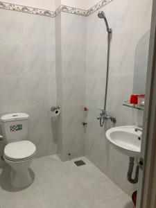 a bathroom with a toilet and a sink at MOON Home in Vung Tau