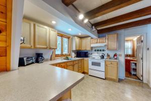 a large kitchen with wooden cabinets and white appliances at 11 Island Drive in Madison