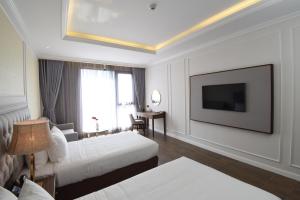 Giường trong phòng chung tại Phu Cuong Hotel Ca Mau