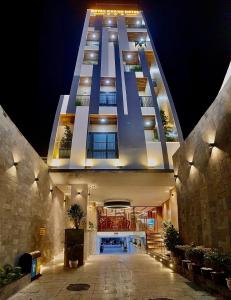 a large building at night with its lights on at Royal Khanh Hotel in Tuy Hoa