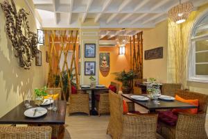 a dining room with two tables and chairs at Botum Palace Hotel in Phnom Penh