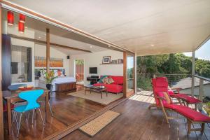 a living room with a red couch and chairs at Byron's Secret in Coorabell Creek