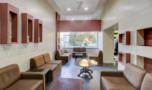 a lobby with couches and a table in a room at Treebo Trend Orange City in Nagpur