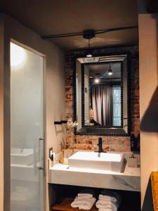 a bathroom with a white sink and a mirror at CASA EMILIA B&B Boutique in Mexico City