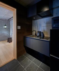 a kitchen with a sink and a counter top at DELTA Stay in Kyoto