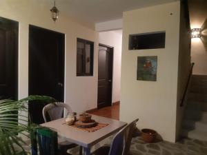 a dining room with a table with a cake on it at Posada Maya in Antigua Guatemala