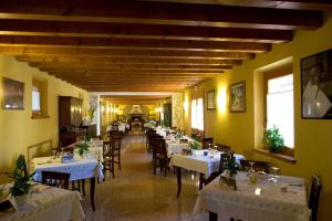 a dining room with tables and chairs in a restaurant at Agriturismo Al Casale in Codroipo