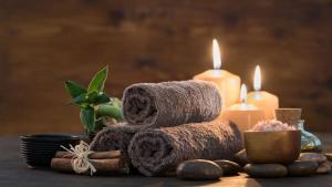 a pile of towels and candles on a table at Pullman Sharjah in Sharjah