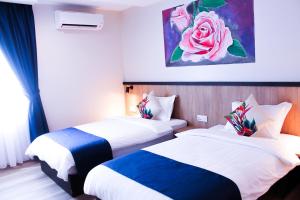 A bed or beds in a room at Savana Hotel & Serviced Apartments