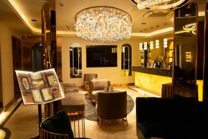 a restaurant with a chandelier and a table and chairs at The Hotel Beyaz Saray - Grand Bazaar in Istanbul