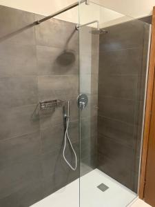 a shower with a glass door in a bathroom at Casa Ercoli PONTORMO in Empoli