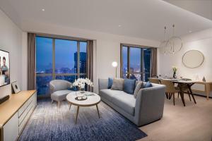 a living room with a couch and a table at Ascott Raffles City Chongqing in Chongqing