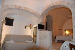 A bed or beds in a room at Trulli don Pietro